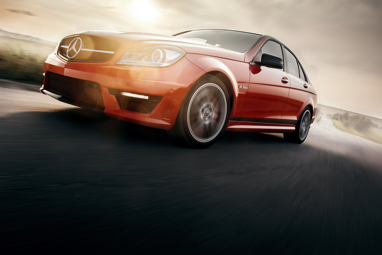 Red Sport Car Drive Speed On Asphalt Road At Sunset